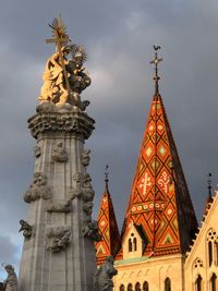 Low angle view of statue against building