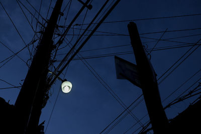 Low angle view of electricity pylon against sky