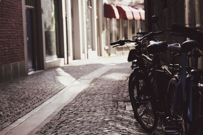 Bicycles parked on street by buildings