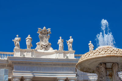 Low angle view of statue against blue sky