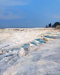 Scenic view of beach against sky during winter