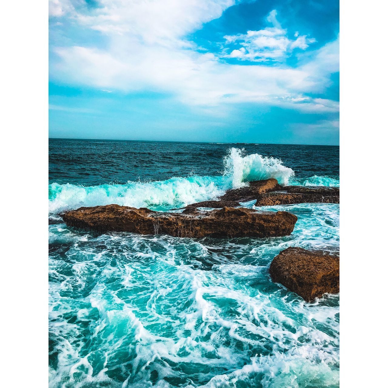 SCENIC VIEW OF SEA WAVES AGAINST SKY