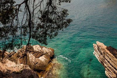 High angle view of rocks by sea