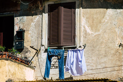 Clothes drying against wall of building