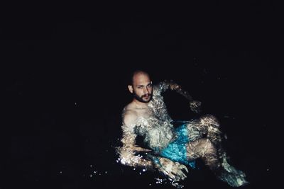 Close-up of man over black background