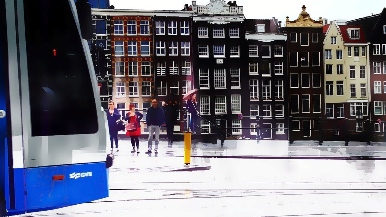 MEN IN CITY AGAINST BLUE SKY