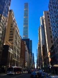 Low angle view of skyscrapers against blue sky