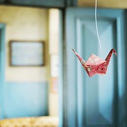 Close up of origami swan hanging at home