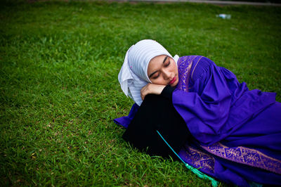 Woman lying on field