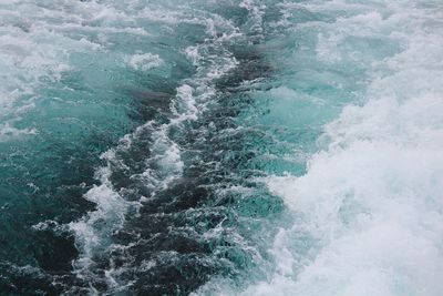 High angle view of waves splashing in sea