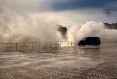 Waves splashing on promenade in stormy weather