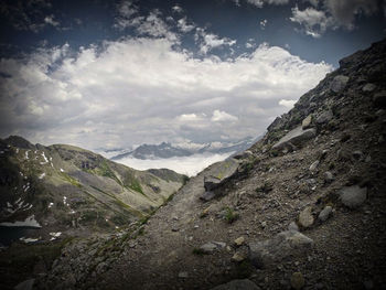 Scenic view of mountains against cloudy sky