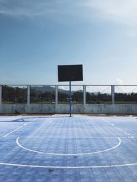 View of basketball hoop against blue sky