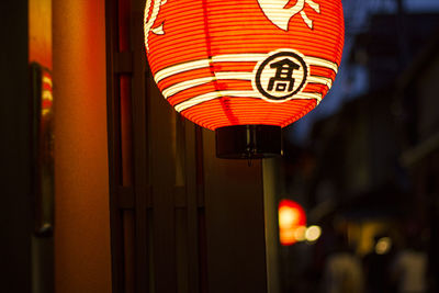 Close-up of illuminated lantern hanging at entrance