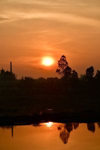 Scenic view of lake against orange sky