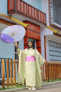 Low angle view of woman with umbrella