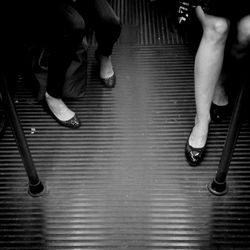 Low section of woman standing on tiled floor