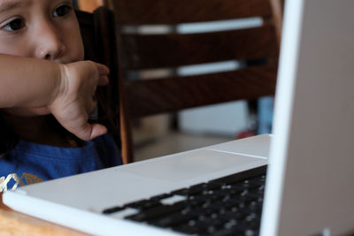 Close-up of child looking at laptop