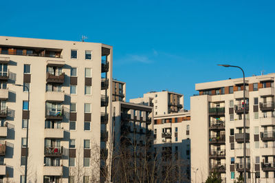 Low angle view of buildings against blue sky
