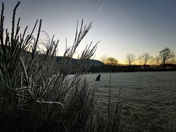 Scenic view of lake against sky during sunset