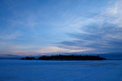 Scenic view of field against sky during winter