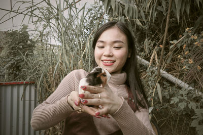 Portrait of young woman sitting on field