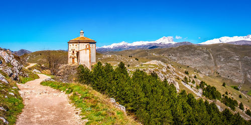 Scenic view of mountains against clear blue sky