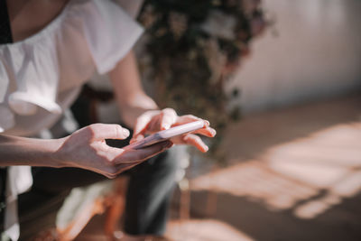 Midsection of man using mobile phone