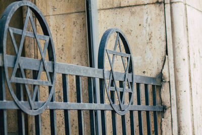 Close-up of old wheel against wall