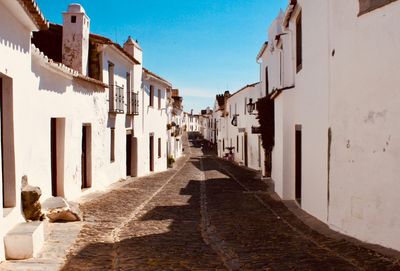 Street amidst buildings against sky in city