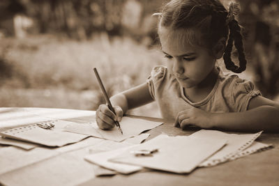 Boy drawing on book