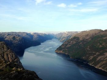 Scenic view of sea and mountains against sky