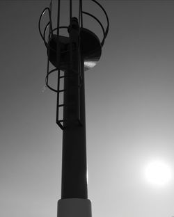 Low angle view of electric lamp against sky