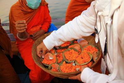 High angle view of man giving flowers to people