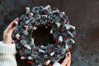 Cropped hands of woman holding christmas decoration