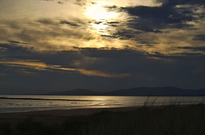 Scenic view of beach against sky during sunset