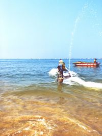 Man in sea against sky