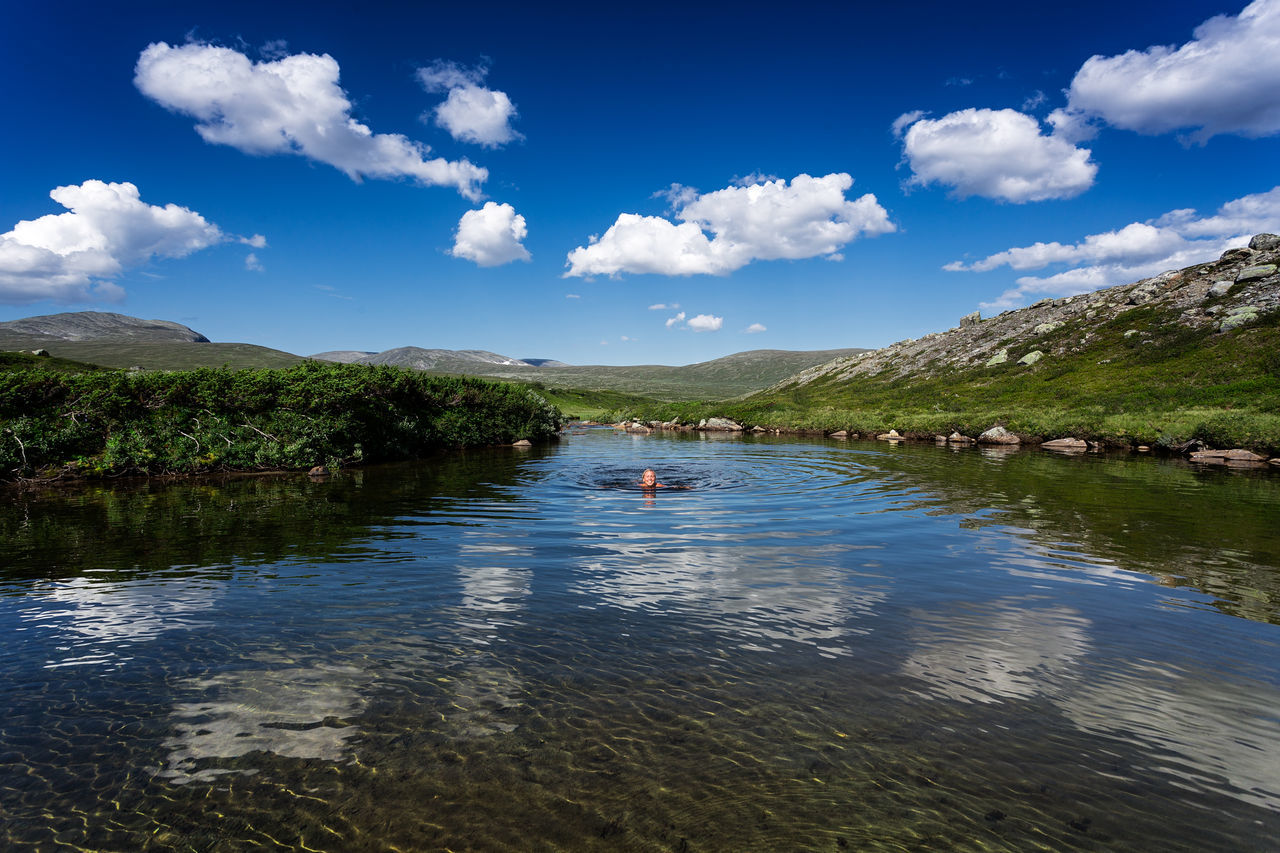 water, sky, transportation, cloud - sky, tree, tranquil scene, cloud, tranquility, scenics, river, nature, nautical vessel, beauty in nature, lake, mountain, mode of transport, boat, blue, day, landscape