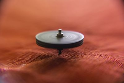 Close-up of light bulb on table