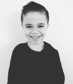 Portrait of smiling boy against white background