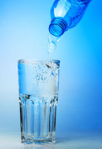 Close-up of wine glass against blue background