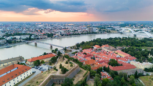 High angle view of townscape by sea against sky