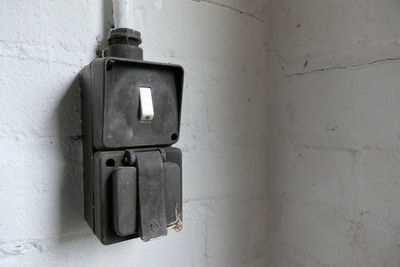 Close-up of electric lamp on wall