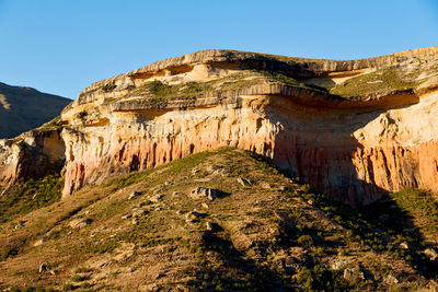 Rock formations on mountain against sky