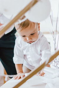 High angle view of cute boy standing on table