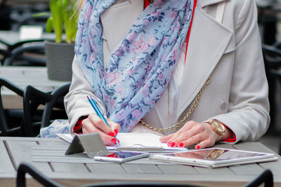 Midsection of woman working on table