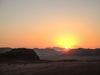 Scenic view of landscape against romantic sky at sunset