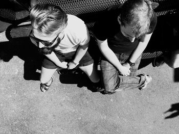 Friends sitting on bench in city