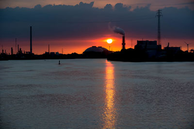 Scenic view of silhouette beach against sky during sunset