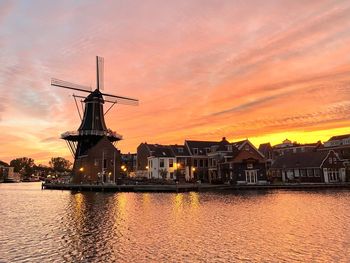 Dutch mill against sky during sunset